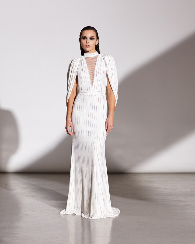 IVORY IRIDESCENT DIAMANTÉ STRETCH VELVET V-PLUNGE ILLUSION BACKLESS GOWN WITH STAND-UP COLLAR AND DRAPED CAPE SLEEVES