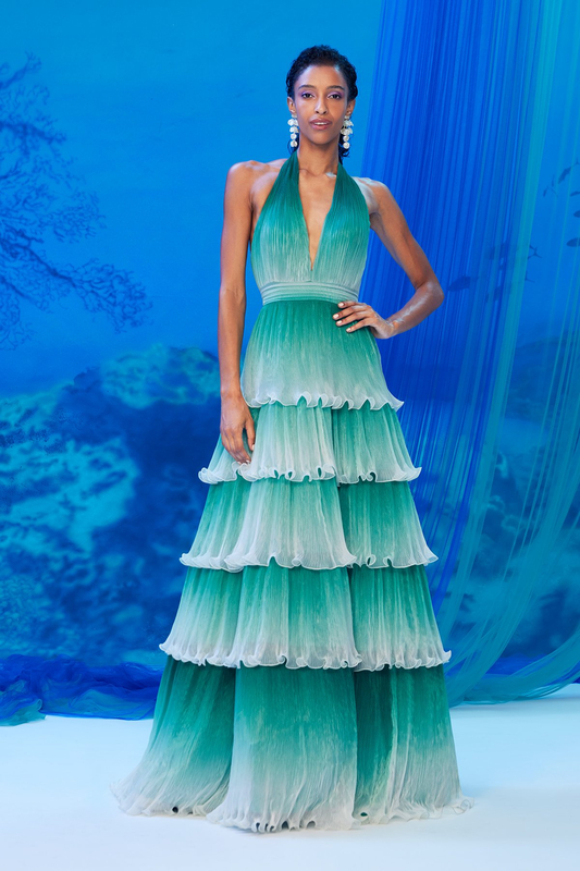 BAMBOO OMBRE PLEATED FOILED CHIFFON HALTER NECK V-PLUNGE TIERED GOWN WITH SEA SPRAY-INSPIRED HEM DETAIL